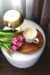 Cup with cappuccino, spring flowers tulips, morning concept, woman's day, bedroom design, gold modern desk lamp