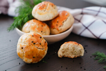 turkish savory pastry pogaca with dill and black sesame or cumin, homemade quick snack