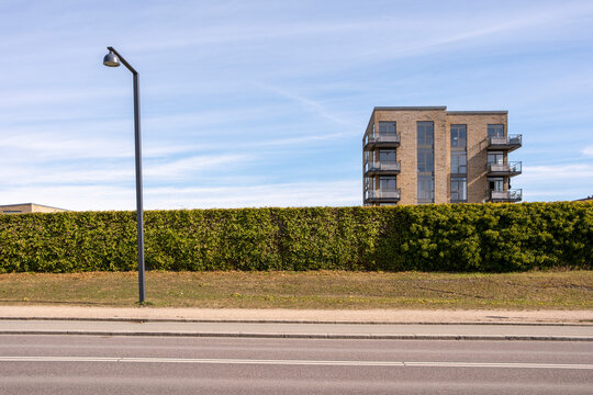 Modern street with residential building and green wall in Orestad, Copenhagen, Denmark, symbolizing urban identity, architectural contrast and the integration of sustainable planning