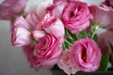 Bouquet of beautiful pink eustoma flowers on the table in the room. Flowers close-up.