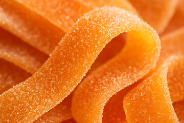 Close-Up of Orange Sugary Candy Strips with Sugar Crystals