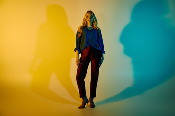 Stylish young woman captivates with bold fashion statement in artistic studio setting