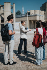 A professor leads a discussion with students outdoors, highlighting collaboration and academic...