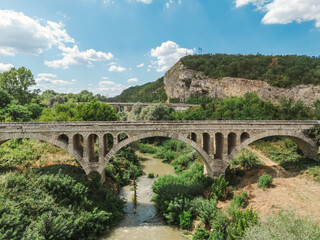 Obraz premium Old Stone Arch Bridge over River in Bulgarian Countryside near Conevo lake