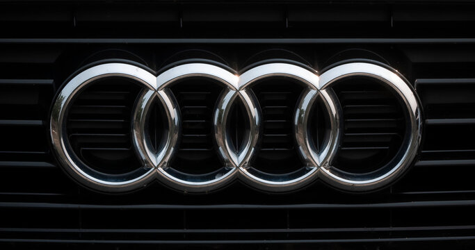 Madrid, Spain; 08-21-2025: Silver Audi logo (the four rings) placed on the front grille of a car, emblem of the German brand symbolizing the merger of four brands creating the company Auto Union AG 