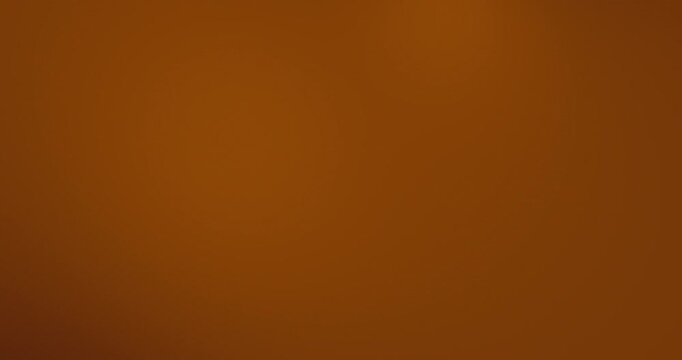 4K Abstract blurred brown beige copper bronze gradient background video. Smooth warm caramel and chocolate color blend with soft fade and subtle glow. Minimal modern backdrop loop for motion graphics