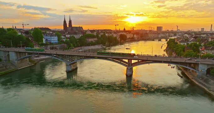 Aerial drone footage of the Basel old town along the Rhine river which contrast with modern skyscrapers in Switzerland. Shot with a forward and rotation motion. 
