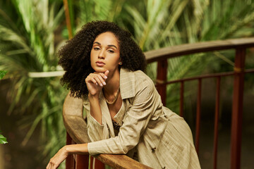 Stylish young woman with curly hair embodies tropical elegance in autumnal fashion