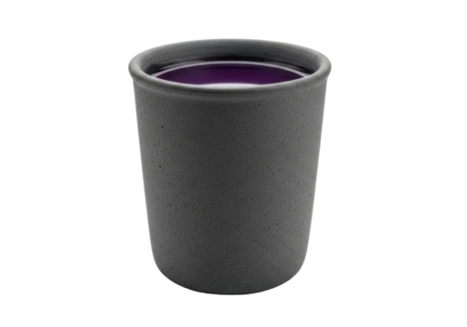 Solitary unglazed charcoal-grey terracotta beaker with raw textured surface, filled to brim with still deep violet liquid, against transparent background with copy space. Ancient elixir concept
