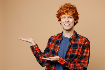 Young smiling happy redhead man he wear red shirt blue t-shirt casual clothes point hands arms...