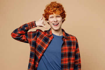 Young happy fun redhead man he wear red shirt blue t-shirt casual clothes doing phone gesture like...