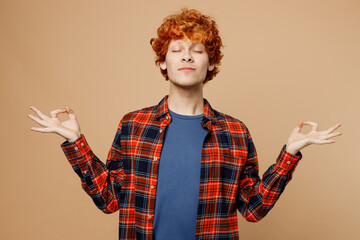 Young redhead man he wear red shirt blue t-shirt casual clothes hold spreading hands in yoga om aum...