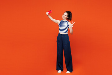 Full body young woman wears blue striped tank top casual clothes doing selfie shot on mobile cell...