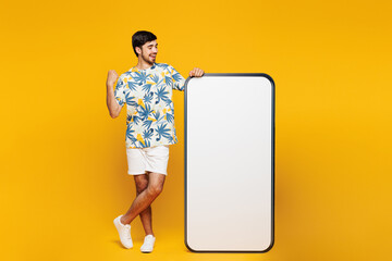 Full body young man he wear blue t-shirt casual clothes big huge blank screen mobile cell phone...