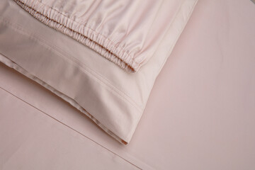 Soft beige fabric draped elegantly on smooth surface showcasing its texture and movement in subtle...