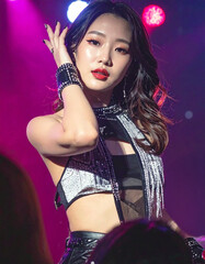 Fototapeta premium Portrait of a beautiful K-pop singer performing under bright stage lights during a concert