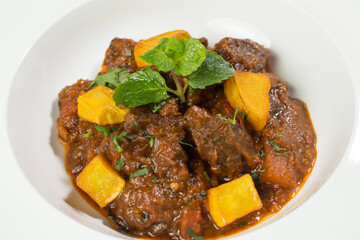Spicy Mutton Vindaloo Karahi with potato in bowl closeup view of Indian Lamb Curry
