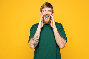 Young Caucasian man he wear green t-shirt casual clothes scream share hot news about sales discount...