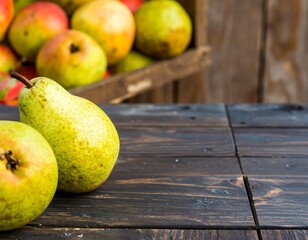 Two ripe pears rest on a dark wooden surface, with a blurred background of more fruit in a rustic crate
