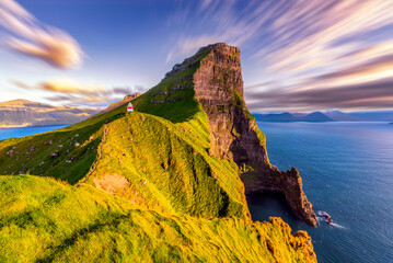 Kallur Lighthouse surrounded by majestic mountain of Kalsoy island