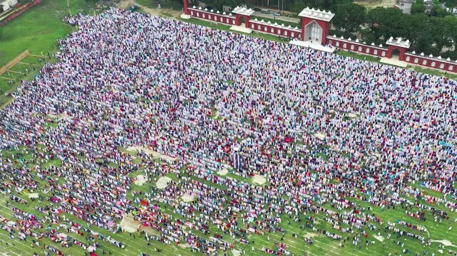 Dinajpur, Bangladesh - 24 August 2025: Aerial view of a vast multitude gathered at Eidgah Maidan, a sea of humanity against the backdrop of red brick walls.