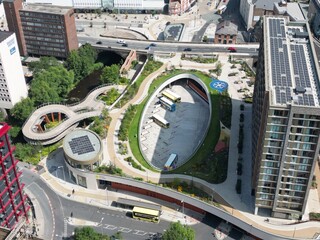 Aerial view of a modern urban park and cityscape.
