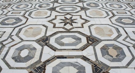 Intricate geometric marble floor pattern with octagonal and star-shaped tessellations in shades of white, grey, and black.