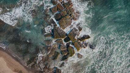 Aerial View of Rocky Coastline with Ocean Waves Crashing in Bali, Indonesia 3