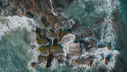 Aerial View of Coastal Breakwater Blocks in Turbulent Waters of Bali, Indonesia
