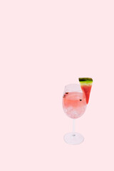Trendy pink cocktail drink with watermelon and ice on light background with copy space. Creative party concept.