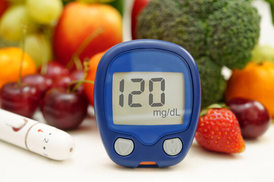 Digital glucose meter for check sample blood sugar level to treatment diabetes with vegetable and fruit healthy.