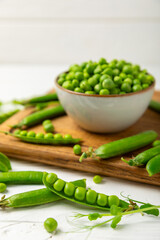 Fresh green pea pods with green peas on a wooden background. Sweet green peas. Green pea beans vegetables. Vegan. healthy vegetable. Copy space