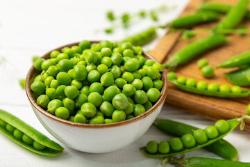 Fresh green pea pods with green peas on a wooden background. Sweet green peas. Green pea beans vegetables. Vegan. healthy vegetable. Copy space