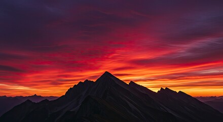 Naklejka premium Fiery Sunset Over Majestic Mountain Range, Dramatic Sky, Vibrant Colors.