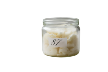 Glass Jar With White Creamy Substance and Number 87 Label