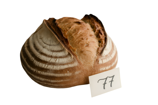 Sourdough bread loaf with number 77 tag baked goods