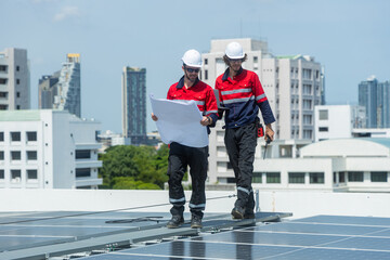 Engineers reviewing solar panel blueprint on rooftop