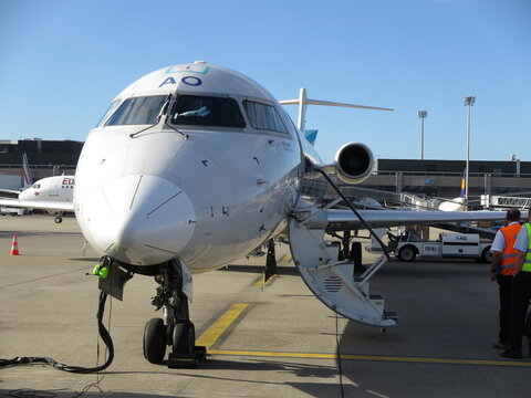 Zurich, Switzerland &ndash; August.22.2016: Adria Airways Bombardier CRJ-900 (flight JP364 from Ljubljana) with passengers disembarking on apron
