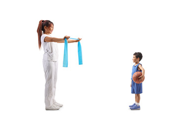 Woman showing an exercise with a rubber band to a boy