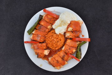 Beyti kebab with rice  on the plate 
