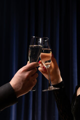 Hands toasting with champagne glasses in restaurant