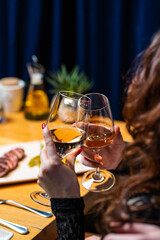 Woman holding glass of wine with steak and asparagus