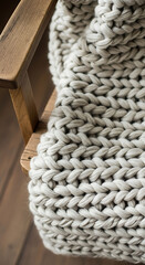 Obraz premium Cozy hygge lifestyle scene featuring chunky knit blanket and natural textures, still life