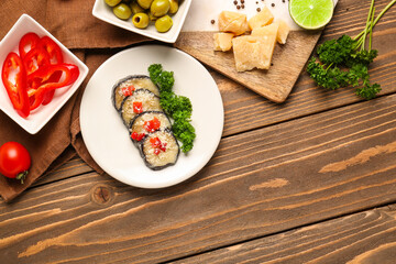 Plate with tasty baked Eggplant Parmesan on wooden background