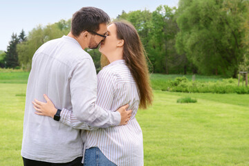 Fototapeta premium Beautiful loving happy couple kissing in park on spring day