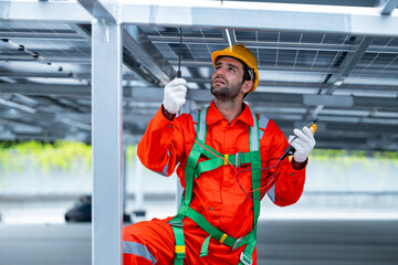Technician testing solar panel electrical connection