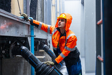 Engineers inspecting industrial pipeline system underground