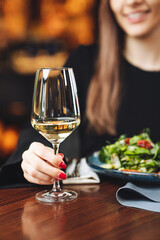 Wine tasting in restaurant – woman enjoying white wine