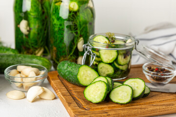 Freshly-salted homemade cucumbers in a jar on a wooden background. pickled cucumbers with dill,garlic and pepper.canned cucumbers.cucumbers and dill.Recipe of homemade preservations.fermented veggies.