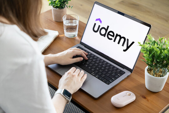 Poznan, Poland - August 23, 2025: Udemy learning platform prominently featured on a laptop screen, as a person actively engages with online courses for skill acquisition